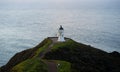 Panoramic view of historic white lighthouse landmark perched on oceanside clifftop Cape Reinga Northland New Zealand Royalty Free Stock Photo