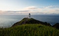 Panoramic view of historic white lighthouse landmark perched on oceanside clifftop Cape Reinga Northland New Zealand Royalty Free Stock Photo