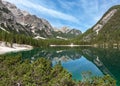 Panoramic view of iconic mount Seekofel mirroring in the clear calm water of Pragser Wildsee Lago di Braies in Dolomites, Italy