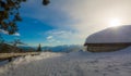 Panoramic view of idyllic winter wonderland with mountain tops and traditional mountain chalet in the Dolomites Royalty Free Stock Photo