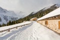 Panoramic view of idyllic winter wonderland with mountain tops and traditional mountain chalet in the Dolomites Royalty Free Stock Photo