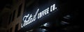 Panoramic view of illuminated LED Foxtail Coffee Co coffee shop sign at night