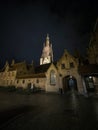 Panoramic view of illuminated catholic gothic cathedral church of our lady Onze Lieve Vrouwekerk at night Bruges Belgium Royalty Free Stock Photo