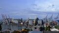 Port landscape with cargo loaders and grain elevators under blue sky Royalty Free Stock Photo