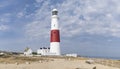 Panoramic view of the Isle of Portland bill lighthouse near Weymoth Dorset coast England UK with a cloudy sky and the ocean in the Royalty Free Stock Photo