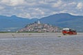 Panoramic view of Janitzio island with statue atop a hill and red boat in Patzcuaro lake in the state of MichoacÃÂ¡n