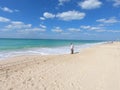 Panoramic View of Jumeirah Beach and Burj Al Arab and View of Pier. Man looking at water at Jumeirah Beach