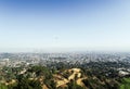 Panoramic view of LA downtown and suburbs from the beautiful Griffith Observatory in Los Angeles, helicopter flying above the city Royalty Free Stock Photo