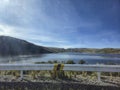Panoramic view of a lagoon next to a road with steel guardrails Royalty Free Stock Photo
