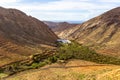 Panoramic view at landscape between Betancuria and Pajara  on Fuerteventura with dammed lake and multi colored volcanic mountais Royalty Free Stock Photo