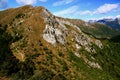 Landscape with mountains and green hills gainst a blue sky with clouds on Mount Cimetta, in Switzerland Royalty Free Stock Photo