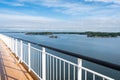 Panoramic view of large beautiful modern cruise ship. Upper deck. The observation deck is surrounded by white railings. Shot from