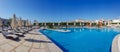 Panoramic view of the large relaxation area with pool and sun loungers