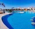 Panoramic view of the large relaxation area with swimming pool and sun loungers