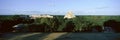 A panoramic view from left to right: Nunnery Quadrangle and the Pyramid of the Magician, Mayan ruin of Uxmal at sunset in the