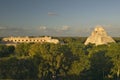 A panoramic view from left to right: Nunnery Quadrangle and the Pyramid of the Magician, Mayan ruin of Uxmal at sunset in the Royalty Free Stock Photo