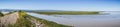 Panoramic view of levee going through the marsh and ponds in south San Francisco bay, California