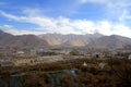 The panoramic view of Lhasa city, in front of Potala Palace and Palace square, with modern building and mountains, far away a Tib Royalty Free Stock Photo