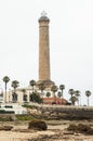 Panoramic view of the lighthouse on Chipiona beach next to palm trees Royalty Free Stock Photo