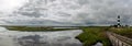 Panoramic view of lighthouse and surrounding marshlands Royalty Free Stock Photo