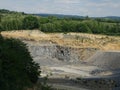 Panoramic view on limestone quarry with power shovel