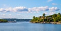 Panoramic view of Lindoya island on Oslofjord harbor near Oslo, Norway, with summer cabin houses at wooded shoreline in early