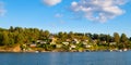 Panoramic view of Lindoya island on Oslofjord harbor near Oslo, Norway, with Lindoya Vest marina and summer cabin houses at
