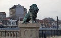 View of Lion`s Bridge from 1889 with lion sculptures, ancient buildings, intersection and traffic lights