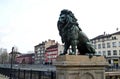 View of Lion`s Bridge from 1889 with lion sculptures, ancient buildings, intersection and traffic lights