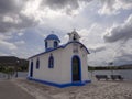 Panoramic view of Little beautiful Greek church in blue and white colors on a sunny day with cumulus clouds of NEA Artaki on the i