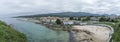 Panoramic view of Llanes, Asturias, Spain, with the beach in the foreground, the entrance to the harbor and the downtown area in