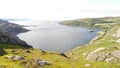 Panoramic view of a loch and hills