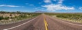 Panoramic view of a long straight road in the desert Royalty Free Stock Photo