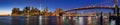 Panoramic view of Lower Manhattan Financial District skyscrapers at twilight with the Brooklyn Bridge and the East River. New York