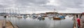 Panoramic view of Lyme Regis\'s famous Cobb breakwater harbour with moored yachts and boats in Lyme Regis, Dorset, UK