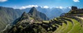 Panoramic view of Machu Picchu ruins in Peru. Behind we can appreciate big and beautiful mountains full of green vegetation. Royalty Free Stock Photo