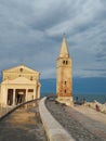 A panoramic view of madonna dell angelo church and lighthouse bell tower at caorle venice italy city seafront rock Royalty Free Stock Photo