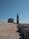 A panoramic view of madonna dell angelo church and lighthouse bell tower at caorle venice italy city seafront rock Royalty Free Stock Photo