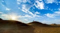 Panoramic view of a man on Sand Dunes in Shipwreck Beach, United Arab Emirates at sunrise Royalty Free Stock Photo