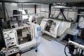 Panoramic view on manufacturing facility with CNC lathe machines. CNC milling machine for working and producing a metal detail. Royalty Free Stock Photo
