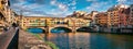 Panoramic view of medieval arched river bridge with Roman origins - Ponte Vecchio over Arno river. Colorful summer cityscape of Fl Royalty Free Stock Photo