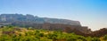 Panoramic view of Mehrangarh fort from Rao Jodha desert rock park, Jodhpur, India. Green vegetation in the foreground and