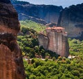 Panoramic view of Meteora monastery on the high rock and road in the mountains at spring time, Greece Royalty Free Stock Photo