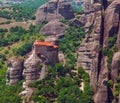 Panoramic view of Meteora monastery on the high rock and road in the mountains at spring time, Greece Royalty Free Stock Photo