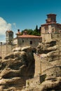 Panoramic view of Meteora monastery on the high rock and road in the mountains at spring time, Greece Royalty Free Stock Photo