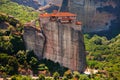 Panoramic view of Meteora monastery on the high rock and road in the mountains at spring time, Greece Royalty Free Stock Photo