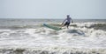 Panoramic view of middle aged man surfing in the Atlantic Ocean Royalty Free Stock Photo
