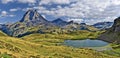 Panoramic view at Midi Ossau mountain peak and Lake Miey, in  Ayous-Bious valley in French Atlantic Pyrenees, as seen in October. Royalty Free Stock Photo