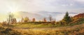 Misty autumn sunrise in hills mountains covered by beech forest.