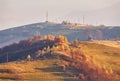 Panoramic view of misty sunny autumn evening in mountains. Beautiful sunset hills landscape. Slopes, meadows, fields, village, Royalty Free Stock Photo